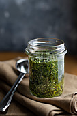 Pesto verde made with parsley, mint and walnuts in a jar