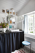 Washstand with dark curtain cover in shabby-chic bathroom