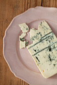 A piece of gorgonzola on a plate