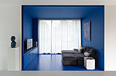 Chaise easy chairs in small living area in blue alcove