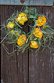 Wreath of rose flowers and grass as a door wreath