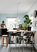 Bar stools at kitchen counter in modern kitchen-dining room