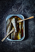 Sardines in a tin with wooden forks