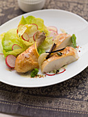 Half a chicken with lettuce and radishes