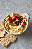 hummus with pomegranate and pumpkin seeds