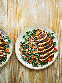 Healthy cumin crusted chicken breast with kale salad and humous