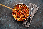 American traditional spaghetti with meatballs, tomato sauce and basil