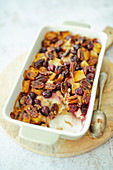 Vegan bread pudding with coconut milk, maple syrup, cherries and pecan nuts