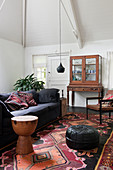 Sofa, Oriental rug and display case in living room