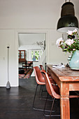 Wooden dining table, classic chairs and pendant lamp