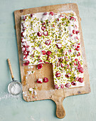 Almond biscuit with raspberry cream and pistachios