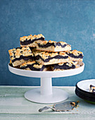 Pieces of poppy seed cake with sprinkles on a cake stand
