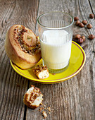 Nut snail and a glass of milk on a plate