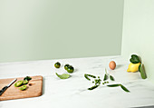 Grüne Tomaten, Erbsen, Ei und Zitrone mit Blättern