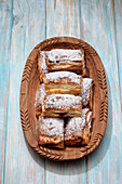 Puff pastry pockets with cherry jam and powdered sugar