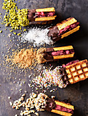 Waffle ice cream sandwiches with raspberry sorbet and various toppings