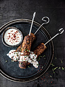 Cevapcici with yoghurt sauce, thyme and chilli flakes