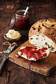 Fruit bread with butter and strawberry jam