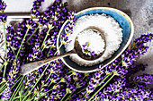 Healthcare concept with fresh lavender flowers and sea salt on stone background with copy space