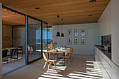 Open-plan interior of modern, architect-designed house with glass walls