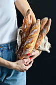 Woman holding French baguettes