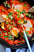 Shakshouka in a pan with bread