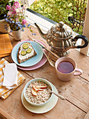 Breakfast with tea, porridge and bread by an open window