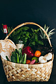 Basket of bread, vegetables, fruits and herbs