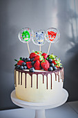 Dripping cake decorated with berries and lollies