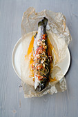 Brown trout in parchment with chilli and ginger