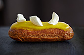 Eclair with glaze and meringue