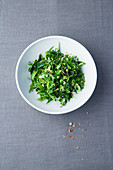 Herb and pine nut salad with dandelions and cinnamon oil