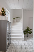 Wooden floor with painted chequered pattern and white staircase in hall