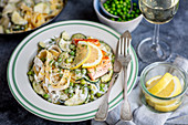 tagliatelle with courgette and green peas in creamy lemon sauce with fried salmon