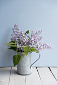 Bouquet of lilac in zinc jug