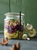 Layered salad with mushrooms, red cabbage and potatoes in a glass jar