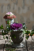 Autumnal arrangement of ornamental cabbage and ivy in urn