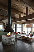 Open fireplace in living room of elegant log cabin