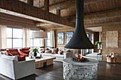 Open fireplace in living room of elegant log cabin