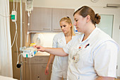 Nurse showing trainee infusion pump