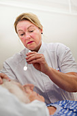 Nurse checking a patient's pupil reactions