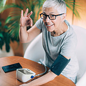 Senior woman measuring blood pressure