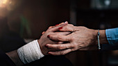 Psychotherapist holding patient's hand