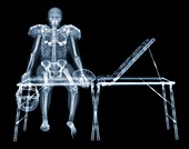 Skeleton of American footballer on sports couch, X-ray