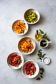 Diced heirloom tomatoes in bowls for bruschetta.