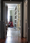 View of marble pillar and bookcase seen through open door