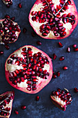 Pieces of pomegranate scattered on a blue background.