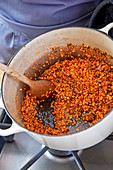 Stirring lentils with spices