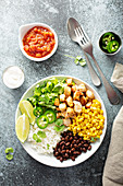 Mexican style lunch bowl with chicken, rice, black beans and corn