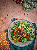 Ras el hanout salmon on vegetable couscous with pomegranate seeds